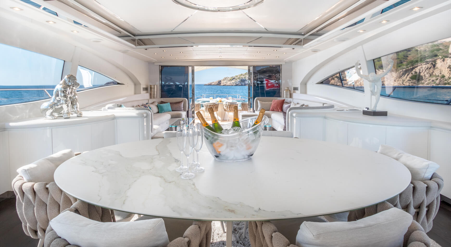 Luxury Yacht with champagne and wine glasses on a marble table, with views out to sea Luxury Yacht with champagne and wine glasses on a marble table, with views out to sea