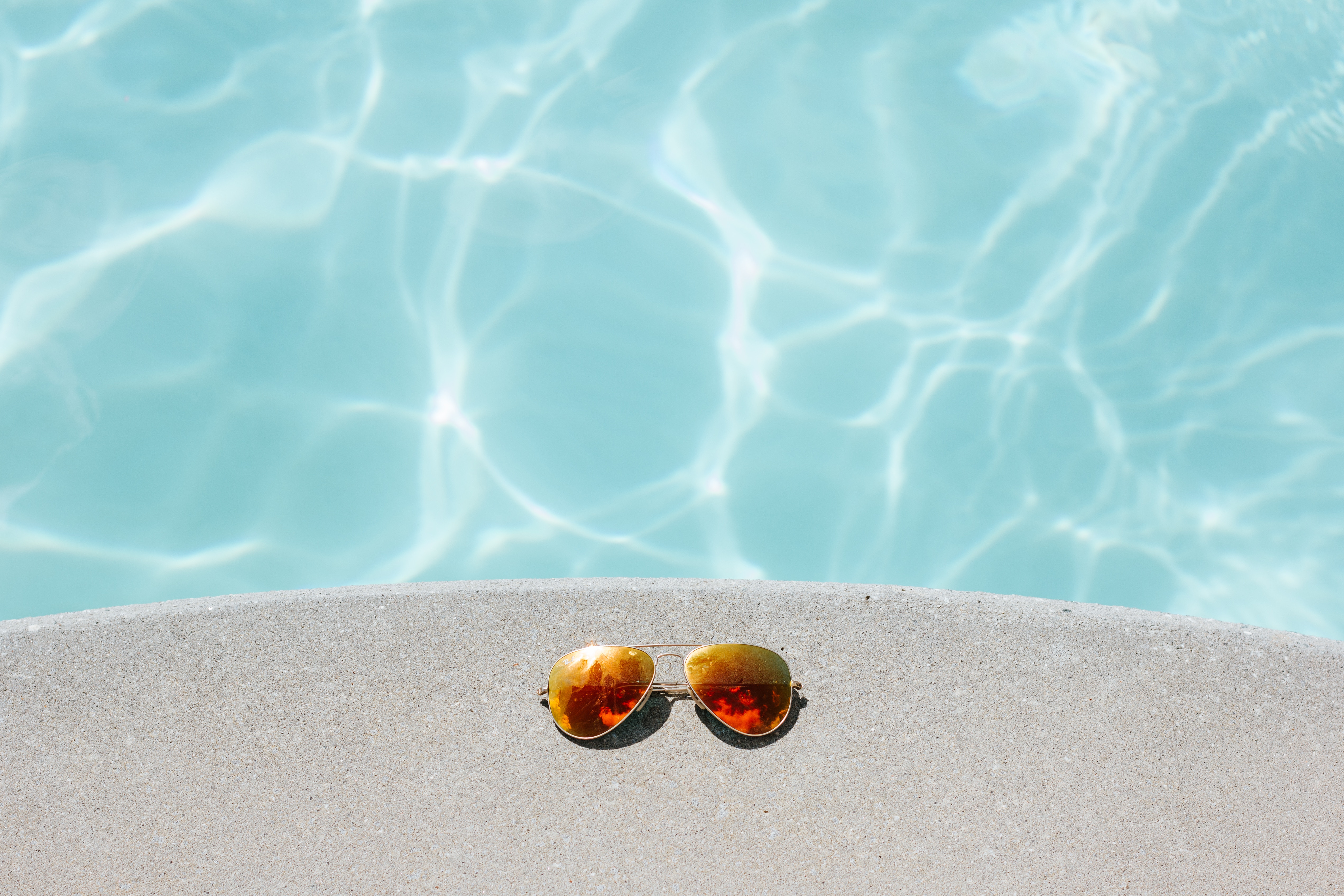 Sunglasses next to pool